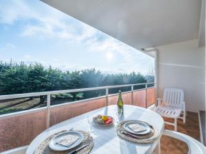 a white table with a bowl of fruit on a balcony at Studio Adal d'Arvor by Interhome in Quiberon