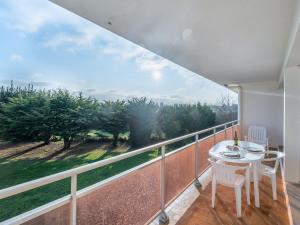 a balcony with a table and chairs and a large window at Studio Adal d'Arvor by Interhome in Quiberon