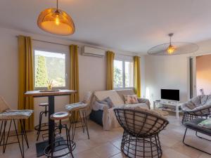 a living room with a couch and chairs and a table at Holiday Home Les Restanques du Vallon by Interhome in Le Lavandou