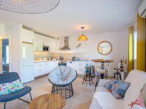 a living room with a couch and a table at Holiday Home Les Restanques du Vallon by Interhome in Le Lavandou