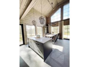 a kitchen with a long table in a room with windows at Holiday Home Willa levi west b by Interhome in Sirkka