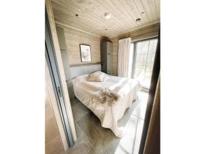 a bedroom with a bed and a window at Holiday Home Willa levi west b by Interhome in Sirkka