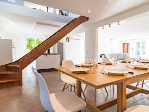 a dining room with a wooden table and chairs at Holiday Home Les Eaux Claires by Interhome in Salernes