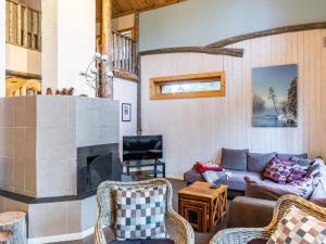 a living room with a couch and a fireplace at Holiday Home Pyhän kivi by Interhome in Pyhätunturi