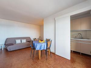 a room with a table and a kitchen with a bed at Apartment Le Palazzo del Mar-12 by Interhome in Cavalaire-sur-Mer