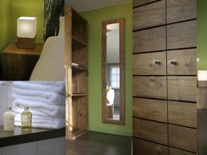 a bedroom with green walls and a bed and a mirror at De Swarte Ruijter in Holten