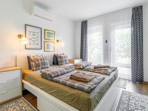 sypialnia z łóżkiem, kanapą i oknem w obiekcie Holiday Home Sunstreet by Interhome w mieście Balatonőszöd