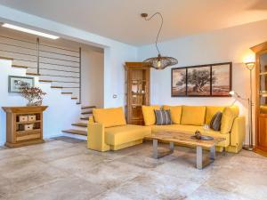a living room with a yellow couch and a table at Holiday Home Villa Pura Vida by Interhome in Savudrija