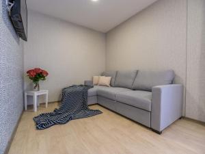 a living room with a couch and a vase of flowers at Holiday Home Seaside mobile home by Interhome in Šilo