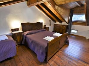 A bed or beds in a room at Studio Albergo Diffuso - Cjasa de Pagnocca by Interhome