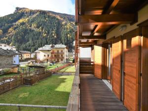 a balcony of a house with a view of a mountain at Apartment Cà Serena by Interhome in Campodolcino