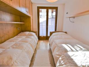 a room with three beds in a room at Apartment Cà Serena by Interhome in Campodolcino