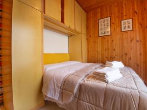 a bedroom with a bed with towels on it at Apartment La Collina by Interhome in Rivisondoli