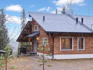 a log home with a gambrel roof at Holiday Home Sallan lumous b by Interhome in Salla +17 photos