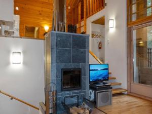a fireplace in a living room with a tv at Holiday Home Sallan lumous b by Interhome in Salla