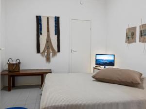 a bedroom with a bed and a desk and a television at Holiday Home Sallan lumous b by Interhome in Salla
