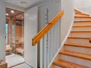 a staircase in a house with white walls and wooden steps at Holiday Home Sallan lumous b by Interhome in Salla