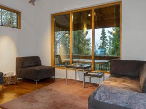a living room with a couch and a chair and a window at Holiday Home Sallan lumous b by Interhome in Salla