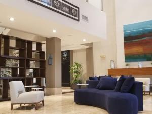 a living room with a blue couch and chairs at Apartment Provident Doral at The Blue-3 by Interhome in Miami
