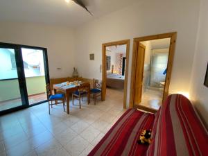 a room with a table and chairs and a dining room at Apartment Blue House by Interhome in La Caletta