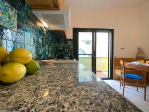 a kitchen with a counter with lemons on it at Apartment Blue House by Interhome in La Caletta +20 photos