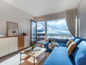 salon z niebieską kanapą i stołem w obiekcie Studio Les Pistes - Lavachet-4 by Interhome w mieście Tignes +14 zdjęć