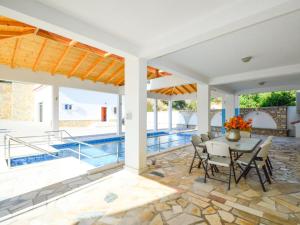 a patio with a table and chairs and a pool at Holiday Home Villa Kursar by Interhome in Zaton
