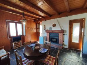 a dining room with a table and a fireplace at Holiday Home Il Crotto by Interhome in Pianello Del Lario