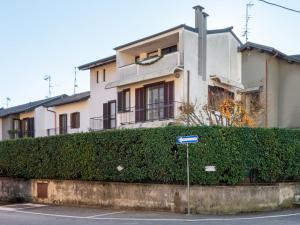 a building with a hedge in front of a street at Apartment da Nuccia by Interhome in Omegna
