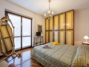 a bedroom with a bed and a large window at Apartment da Nuccia by Interhome in Omegna
