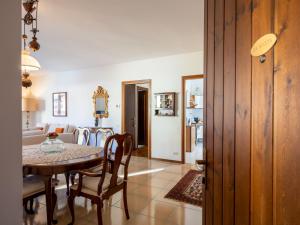 a dining room and living room with a table and chairs at Apartment da Nuccia by Interhome in Omegna