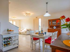 a kitchen and dining room with a table and chairs at Holiday Home del Sole by Interhome in Bientina
