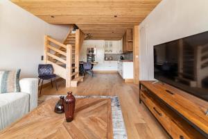 a living room with a large flat screen tv at Cocon au pied des pistes de ski du Mont-d'Arbois in Megève