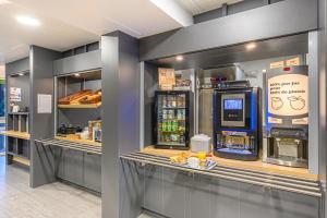 a store with a drink counter with a drink cooler at B&B HOTEL Vannes Est Golfe du Morbihan in Vannes