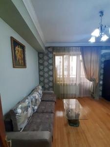 a living room with a couch and a table at New Build Apartment On Argishti Street in Yerevan