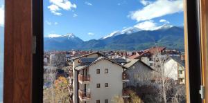 a view from a window of a city with mountains at Pirin Sunrise in Bansko