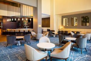 a lobby with tables and chairs and a bar at Hyatt Regency Morristown in Morristown