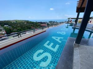 a swimming pool on the roof of a building at Phuket Condominium Karon beach in Karon Beach