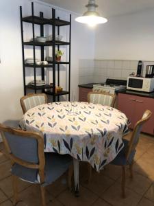 a kitchen with a table with a table cloth on it at Dpto Pque in Azul