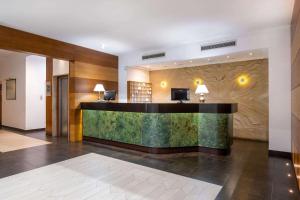 a lobby of a hotel with a reception desk at Quality Hotel Nova Domus in Rome