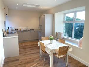 a kitchen and dining room with a table and chairs at Pass the Keys Beautiful 5BR Rural Cottage with Outstanding Views in Castle Douglas
