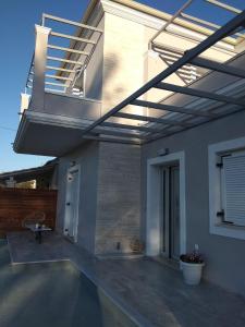 a patio with awning on the side of a house at Spiridoula Luxury Villa in Roda