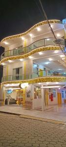 a large building with a balcony on top of it at Hotel Pousada Família de Nazaré in Cachoeira Paulista