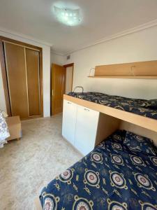 A bed or beds in a room at Apartamento vacacional Urb. Nerea II REF. 065