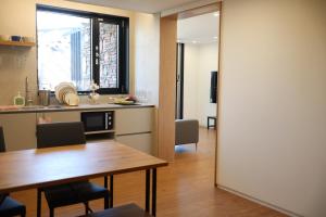 a kitchen and dining room with a table and a window at Hotel Kyungsung in Busan