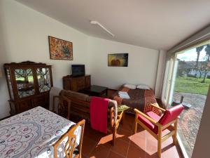 a room with a bed and a table and chairs at Casa da Cabração - Circuito Aldeias de Portugal in Ponte de Lima