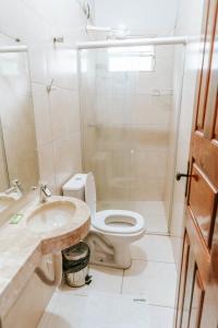a bathroom with a toilet and a sink at Pousada Igarapé in Barreirinhas