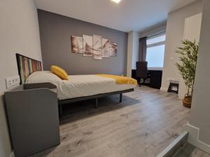 a bedroom with a bed and a desk in it at Malasaña Dreams S,L in Madrid