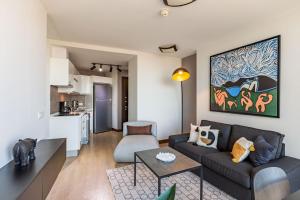 a living room with a couch and a table at Charming Flat with Gorgeous City View in Atasehir in Istanbul