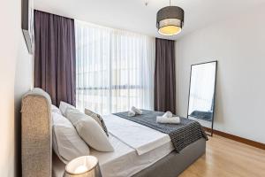 a bedroom with a bed and a large window at Charming Flat with Gorgeous City View in Atasehir in Istanbul